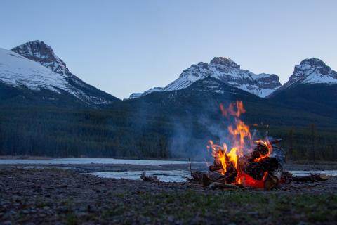 campfire in front of mountains