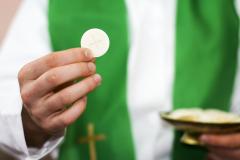 Image of priest holding Communion wafer