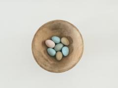 Pastel Easter eggs in a wooden bowl