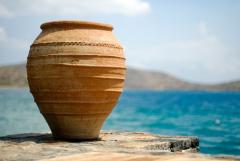 A clay jar in front of water