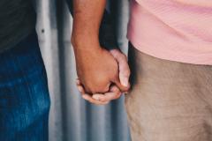 two hands with different skin tones holding each other