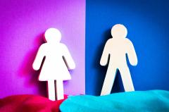 male and female figures against a pink and blue background